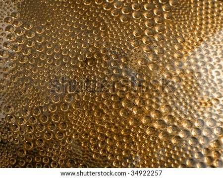Bubble-textured glass with an orange-gold color overlay.