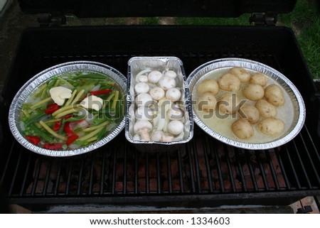 Three containers full of vegetables on the BBQ