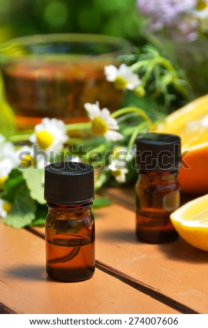 essential oils with fruits and herbs for aromatherapy treatment
