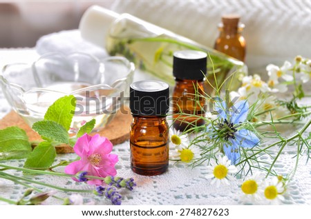 essential oils and natural cosmetics with rose flowers for aromatherapy treatment