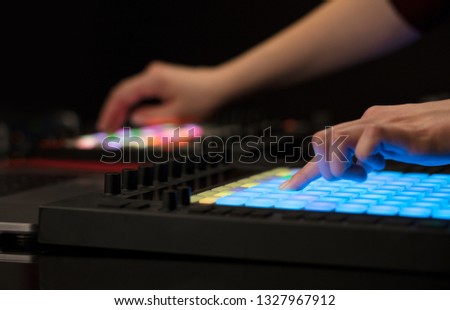 Dj hand remixing music on midi controller