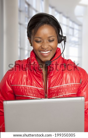 Young  South African woman on internet voice chat helping a customer.