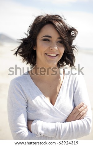 Young woman with a happy smile on a Cape Town beach.