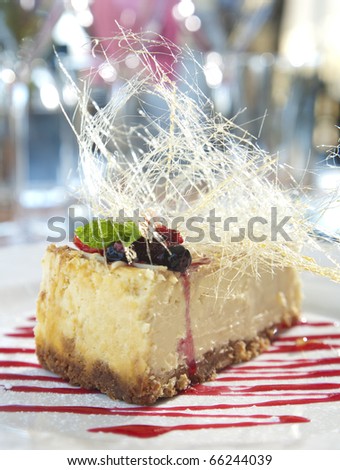 Fridge cheesecake with berries and sugar art as decoration.