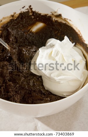 Cream being folded into chocolate cake mix