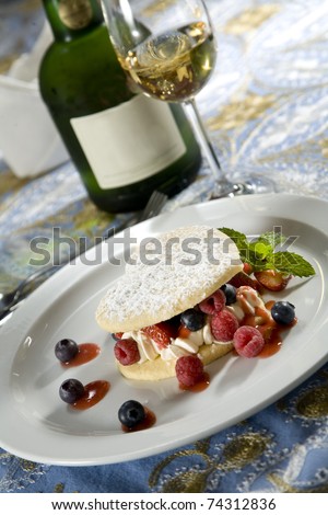 Heart shaped short-bread, with wild berry filling on a white plate, paired with a sweet dessert wine.