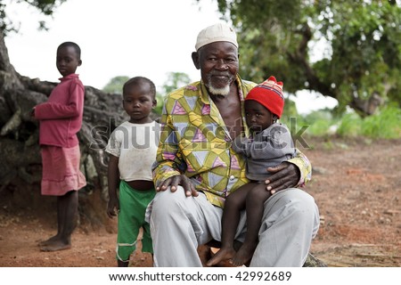 BURKINA FASO - AUGUST 12: Elder Lobi with baby, the elders have an important role making decisions on community standards, August 12, 2009 in Gaoua, Burkina Faso