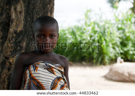 BURKINA FASO - AUGUST 12: Girl posing Lobi ethnic, women are responsible for the tasks of the village while the men work the fields, August 12, 2009 in Gaoua, Burkina Faso