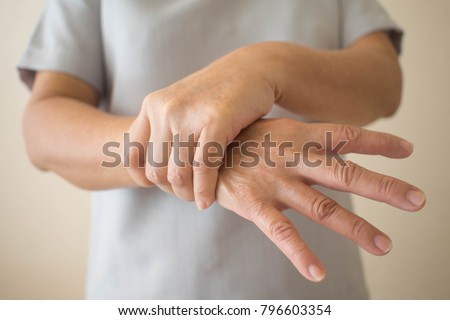 Parkinson\'s disease symptoms. Close up of tremor (shaking) hands of Middle-aged women patient with Parkinson\'s disease. Mental health and neurological disorders.