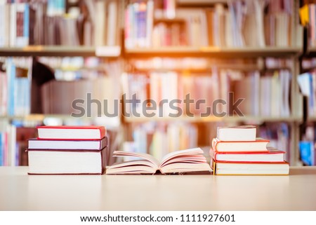 Book stack is placed on the library desk. education background, back to school concept.