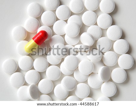 yellow-red tablet  lies on white tablets