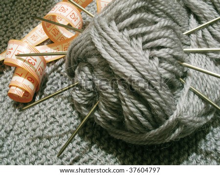 Clew of wool and knitting needle