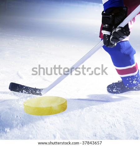 ice hockey player shoots golden puck