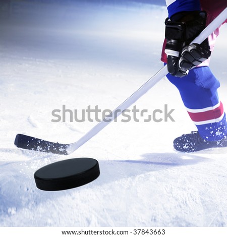 ice hockey player shoots puck