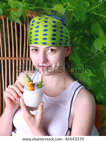 girl in the garden of eating healthy food is useful cocktail with celery and carrots
