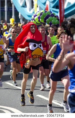 LONDON, UK - APR. 22: A man dresses in fancy dress as tens of thousands of people pass Tower Bridge during the London Marathon on the Apr 22, 2012 in London, UK