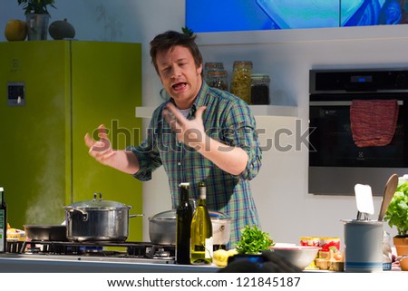 LONDON - DECEMBER 12: Jamie Oliver performs a cooking demo in London, England, on Wednesday, December 12, 2012