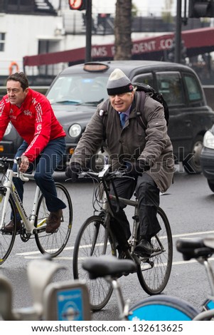 LONDON, UK - MAR 15: London Mayor Boris Johnson rides his bike in London on the MAR 15, 2013 in London, UK