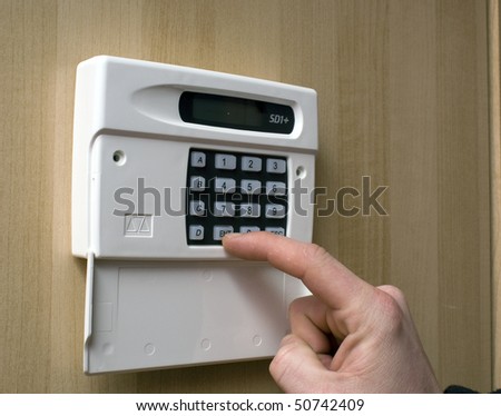Image of a man setting a burglar alarm