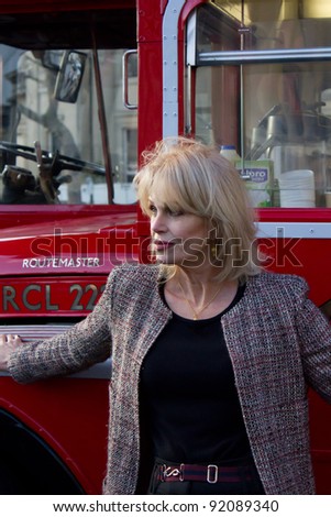 LONDON, UK - January 5 Actress Joanna Lumley poses in front of a Red London double decker in Trafalger Square London on the January 5, 2012 in London, UK