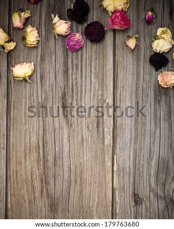 Dry roses on old wood background with copy space