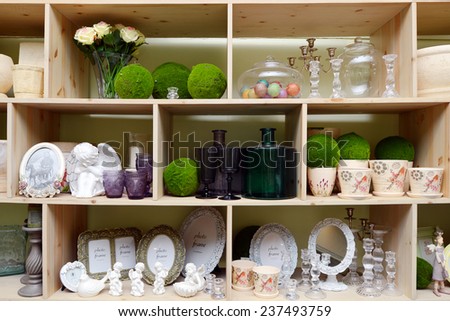 wooden shelf with vases, bottles and photo frames