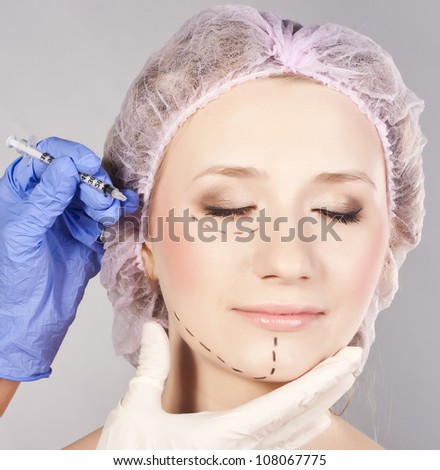 Drawn lines on woman\'s face, marks for facial plastic surgery