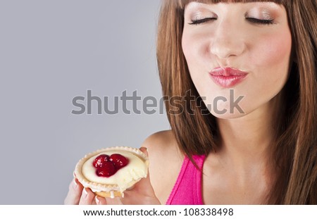 Woman with cake. Close-up studio portrait.