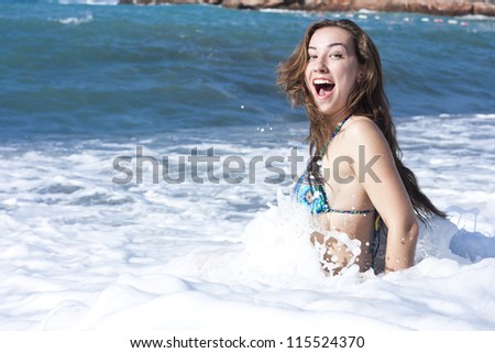 Young attractive lady swimming in the sea