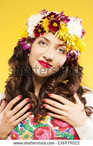 brunette with red lipstick in the studio. floral arrangement