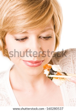 woman holding sushi rolls. Young woman in the studio. sushi