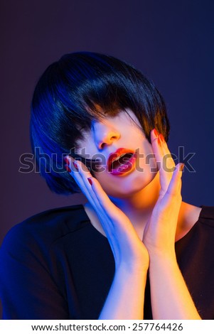 woman with short hair and dark hair. red lips