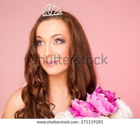 girl with hair style looking to the side. hair crown. on a pink background