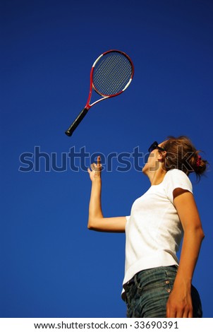 Young woman playing tennis in the sun