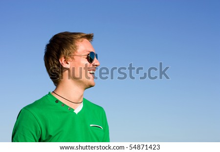 Young man laughs in sunglasses