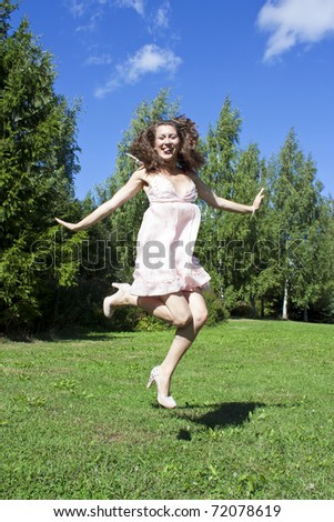 Beautiful girl jumping in the park