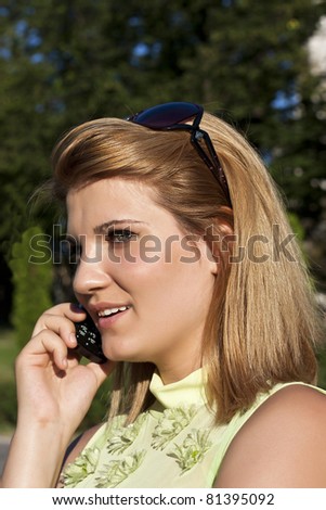 Beautiful businesswoman make call by mobile cell phone. Outdoor, over city