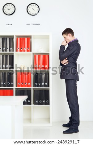 businessman lost in thought in his office