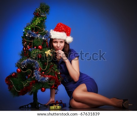 beautiful girl lay near christmas tree