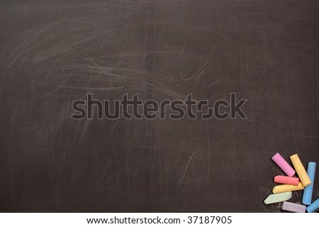 The scratched used up school board with a colour chalk