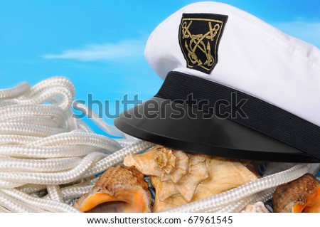 Captain\'s peak-cap, cockleshells against the blue sky