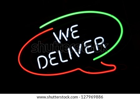 We Deliver sign in Italian colors on pizzeria\'s window