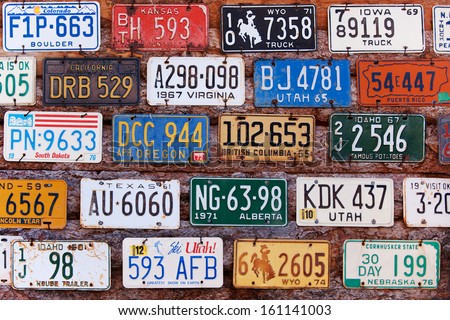 UTAH, USA - NOVEMBER 16: Various old American license plates behind antique gas pump on November 16, 2008. License plates are from various American states.