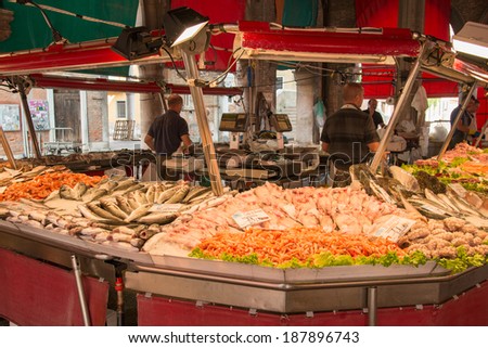 VENICE, ITALY - JUNE 17: Fish stand on famous Rialto market in Venice on June 17, 2013. Market workers selling various fish and seafood in the morning