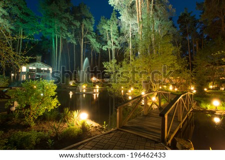Cozy resort by the lake in the conifer forest at night