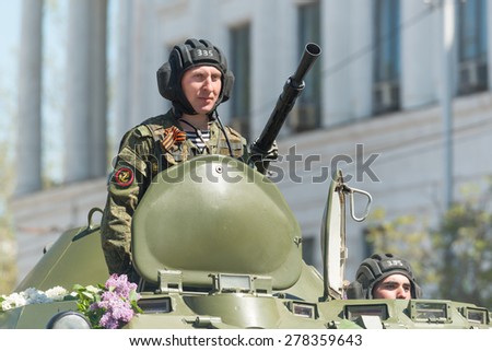 SEVASTOPOL, CRIMEA - MAY 9: The Victory Day parade of veterans and Russian military in honor of 70th anniversary on May 9, 2015 in downtown Sevastopol, Crimea. Crew of BTR-80 is greeted by the crowd.