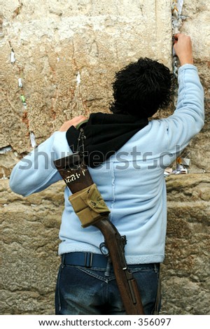 making a wish: placing a note in Jerusalem Western wall