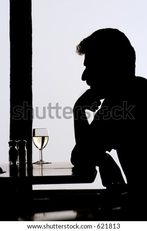Man sitting alone in the restaurant with a glass of wine