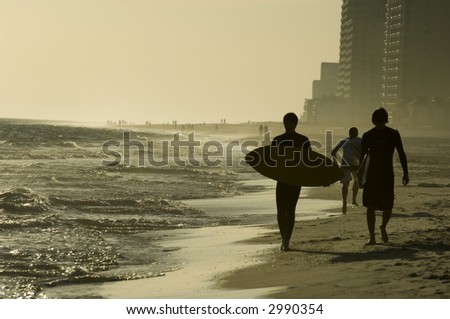 Teens with surfboards on the beach of Gulf of Mexico during school break