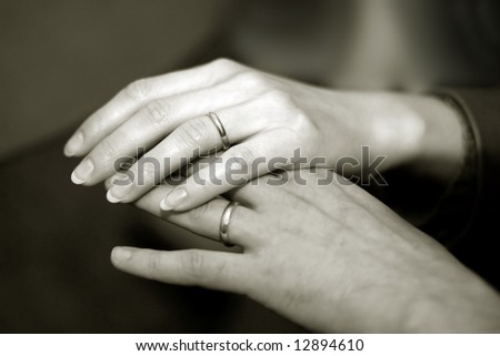 stock photo Just married couple holding hands with wedding rings